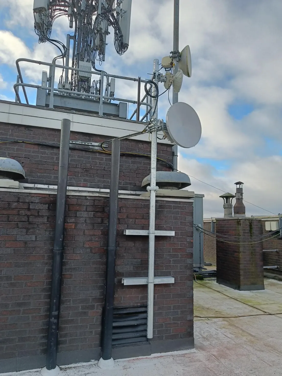 Wireless link dishes mounted on a rooftop